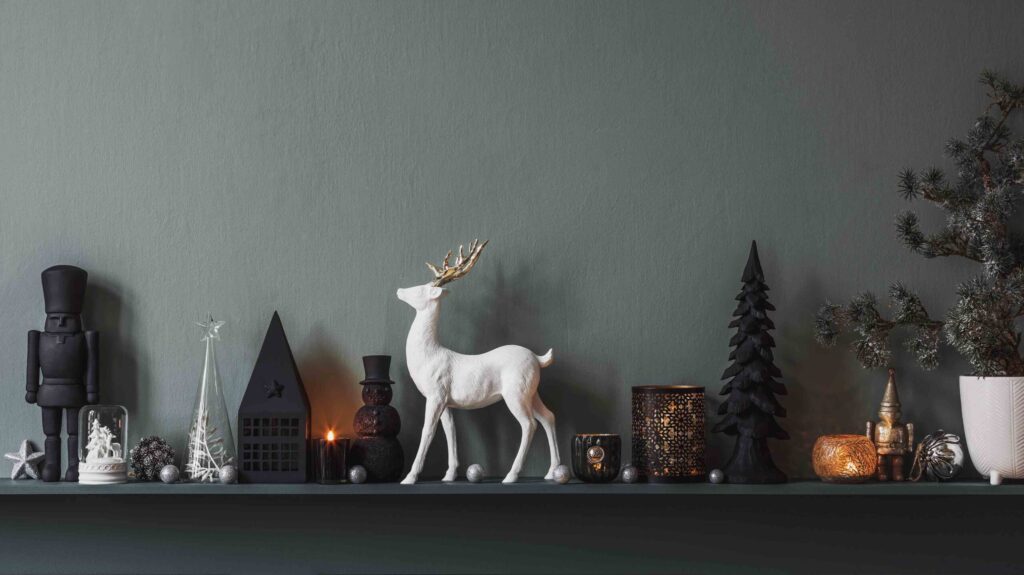 Christmas composition on the shelf in the living room interior. Beautiful decoration. Christmas trees, candles, stars, light and elegant accessories. Merry Christmas and Happy Holiday. Template.