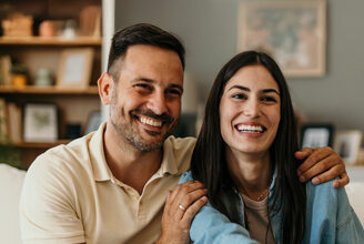 Younger veteran couple speaking with real estate agent.