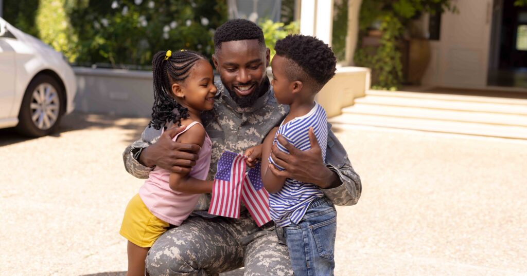 African american army soldier father embracing cute children out
