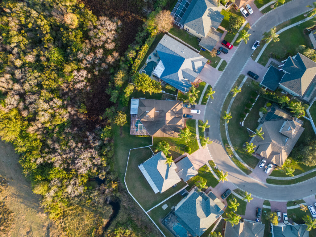 Top down view of Florida Home with Pool enclosure in neighborhood near Tampa florida from aerial drone