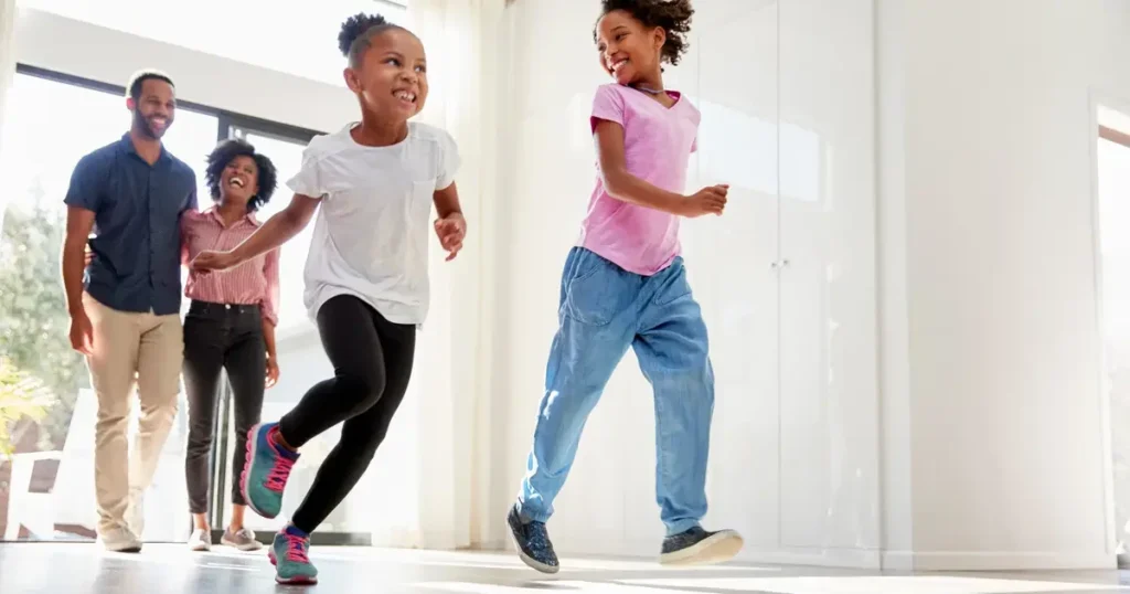 Family happily running through door