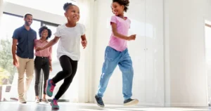 Family happily running through door