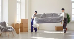 Two men carrying a couch.
