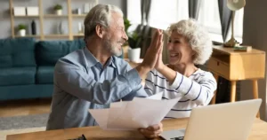 Retired couple high-fiving
