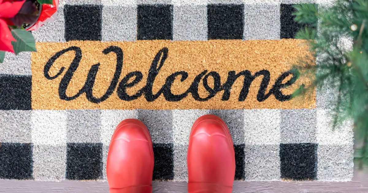 Red boots on a welcome mat