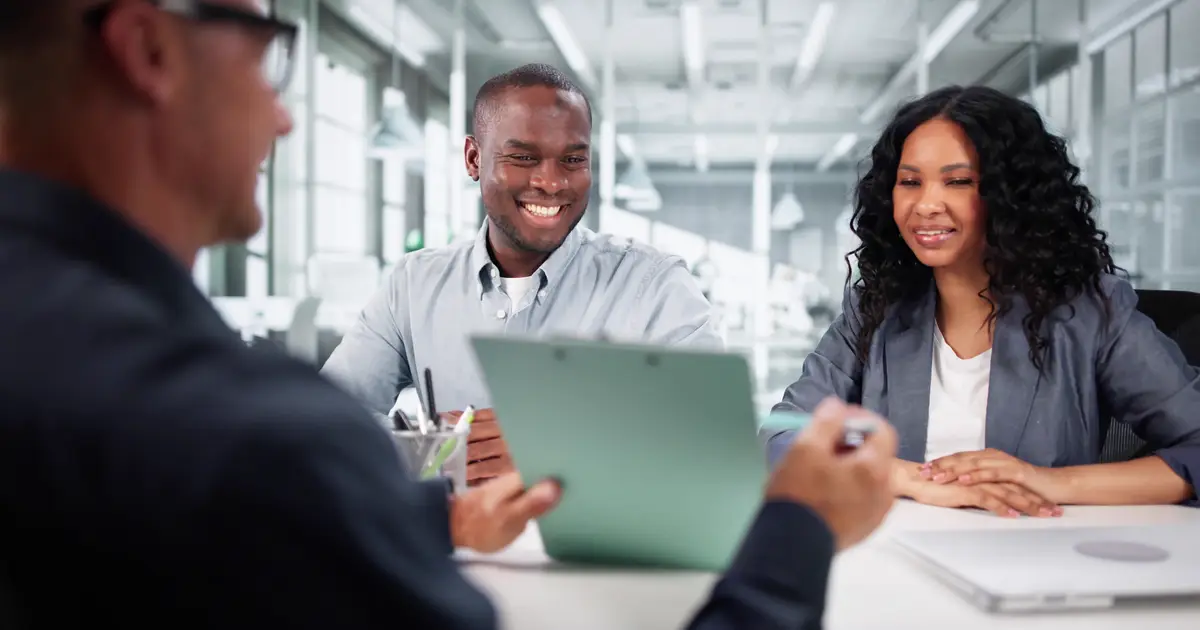Agent meeting with smiling couple