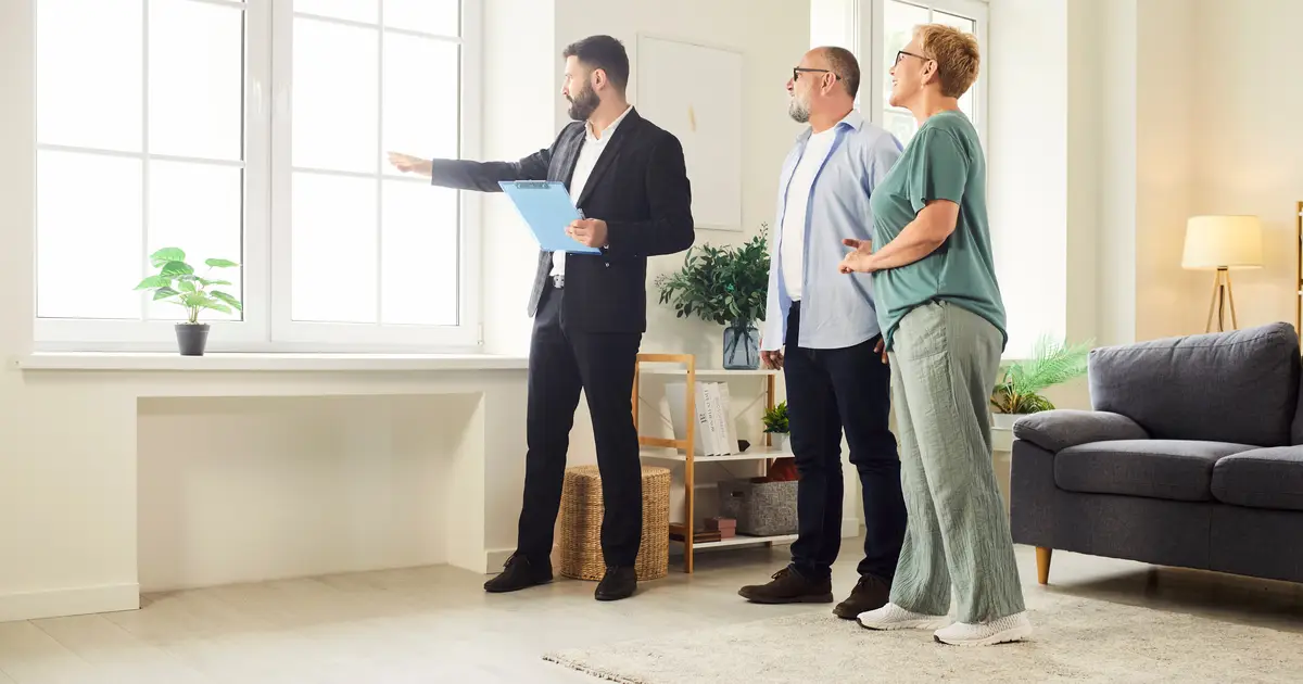 agent showing house to happy couple